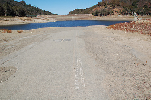 A stretch of the Glenwood or Old Santa Cruz Highway surfaces above the waters of Lexington Reservoir. October, 2014. Note the white lines: it's the original paint! Photo © Mobile Ranger.