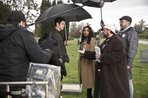 The Flash -- " The Runaway Dinosaur" -- Image: FLA221b_bts_0320b.jpg -- Pictured (L-R): Behind the scenes with Grant Gustin as Barry Allen, Candice Patton as Iris West and Kevin Smith -- Photo: Katie Yu/The CW -- é 2016 The CW Network, LLC. All rights reserved.