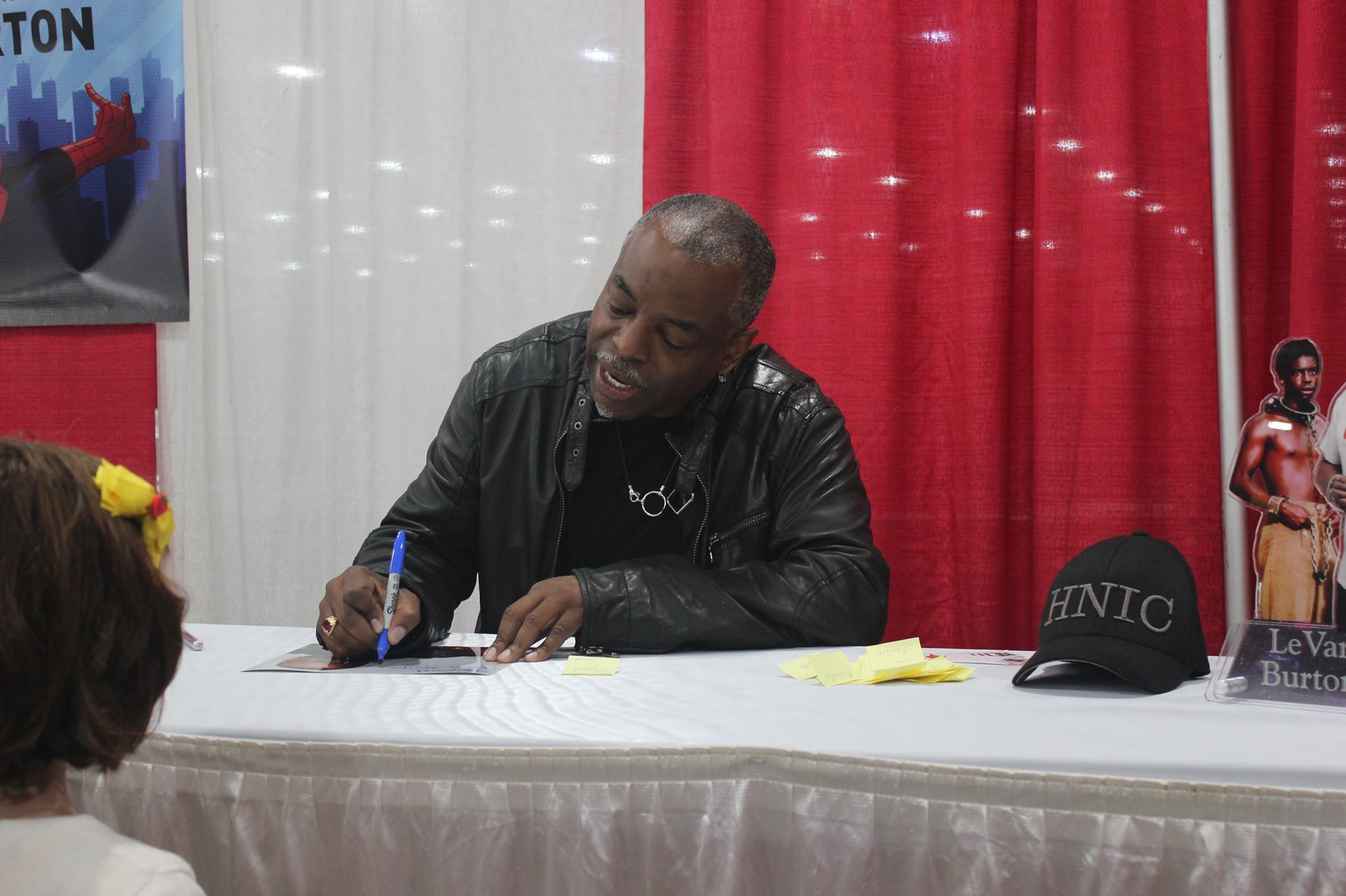 LeVar Buton signs an autograph for a young fan.