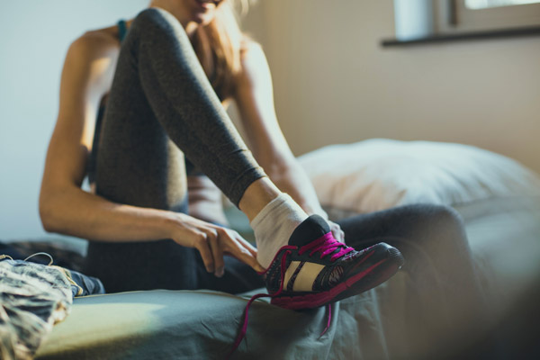 Photo of woman lacing up her shoes