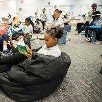 Photos of students engaged in a variety of learning activities based on their choice such as reading or practice on devices