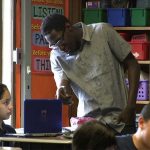 Photo of West Belden school badge and teacher with student