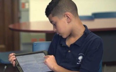 Photo of male student working on tablet