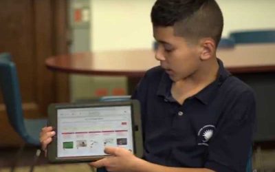 Photo of student explaining tablet presentation
