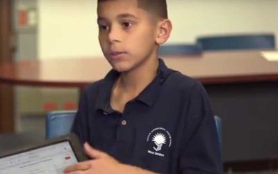Photo of student explaining tablet presentation