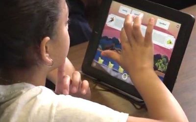 Photo of student working on her tablet device
