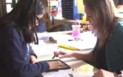 Photo of teacher and student in conference using tablet device