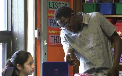 Photo of student and teacher working together on laptop
