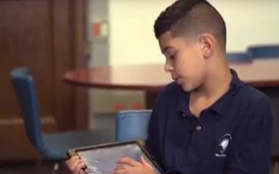 Photo of student explaining tablet presentation