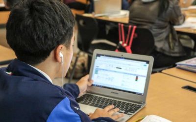 Photo of student and his laptop with screen showing data dashboard