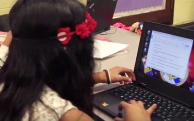 Photo of student working on her laptop computer