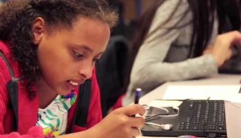 Photo of student working in her notebook