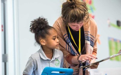 Photo of teacher and student working one-to-one