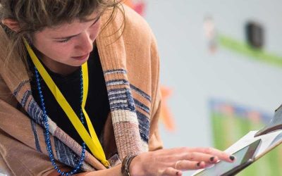 Photo closeup of teacher analyzing data on tablet screen