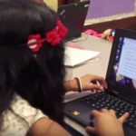 Photo of student working on her laptop computer