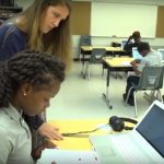 Photo of student and teacher working together at desk