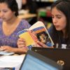 Photo of student reading Shakespeare with another student in background
