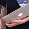 Photo closeup of teacher holding laptop