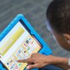 Photo closeup of student working on tablet device