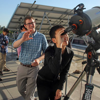 Garreth Ruane, a postdoctoral scholar in astronomy, shows visiting students from South Pasadena High School filtered views of the sun.
