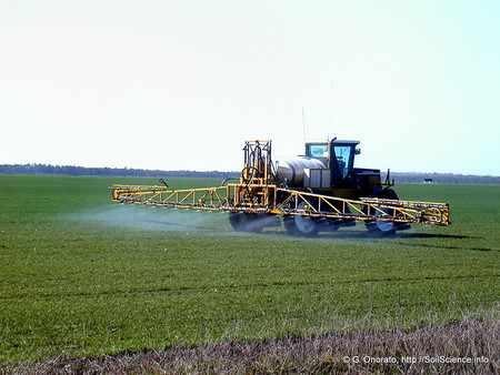 Fertilizer is applied to an agricultural field.