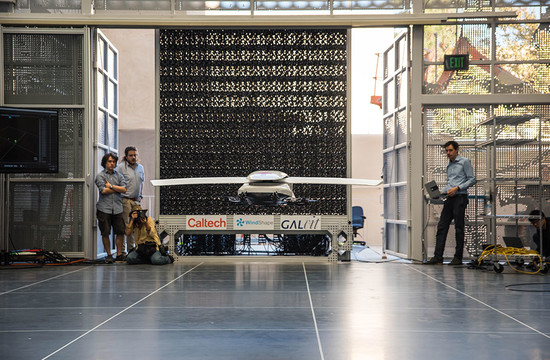 photo of a scale model of the Autonomous Flying Ambulance being developed at CAST hovering in front of the wall of fans