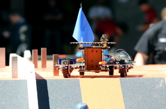 The Team V15ta robot drops a ball down the ramp at the end of the obstacle course.
