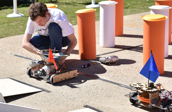 Team Soul's Joel Kosmatka prepares a robot for the start of a new heat.