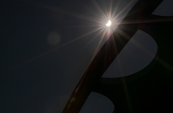 photo of the crescent-shaped sun near the roof line of Beckman Auditorium