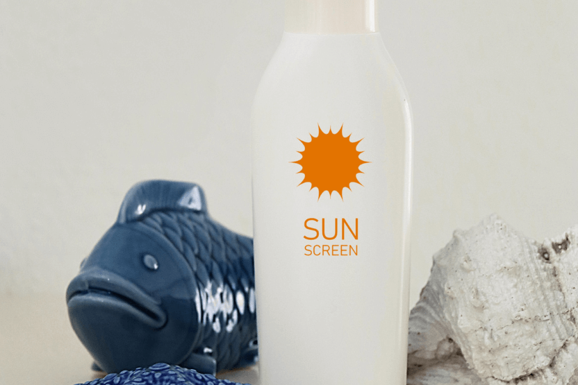 Bottle of sunscreen with shells