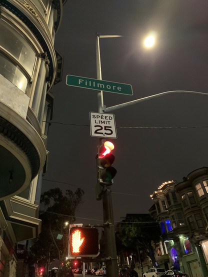 The other side of the sign. It says Fillmore and is green