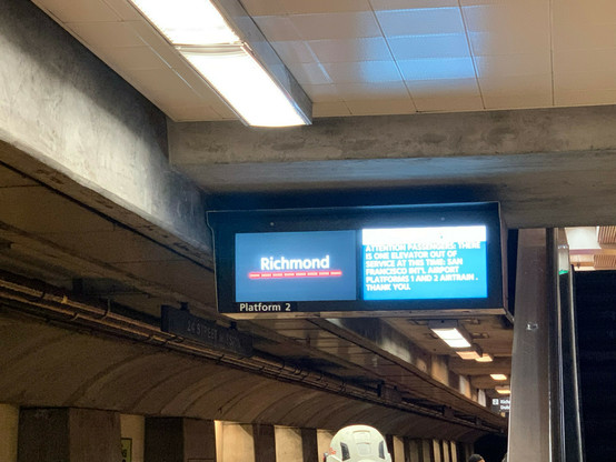 Digital sign on train platform for an arriving train, saying “Richmond” with a dotted horizontal line colored red beneath it.