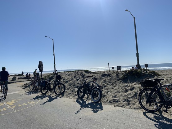 Five bikes at four bike racks along the Sunset Dunes median