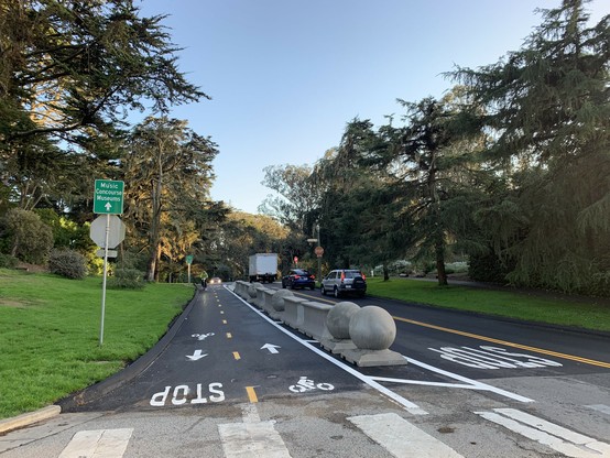 A two-way bike path separated by concrete barriers on a road in a park