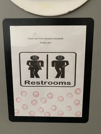 sign on door: Please wait if the restroom is occupied. Thank you