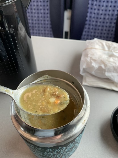 Hot soup in a spoon and in the mug