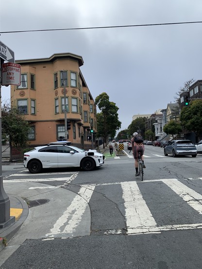 On a green light, a crossing Waymo has managed to block both the crosswalk and much of the bike lane.