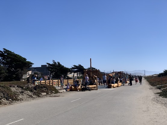 A crowded playground spilling out of where the median of a highway used to be