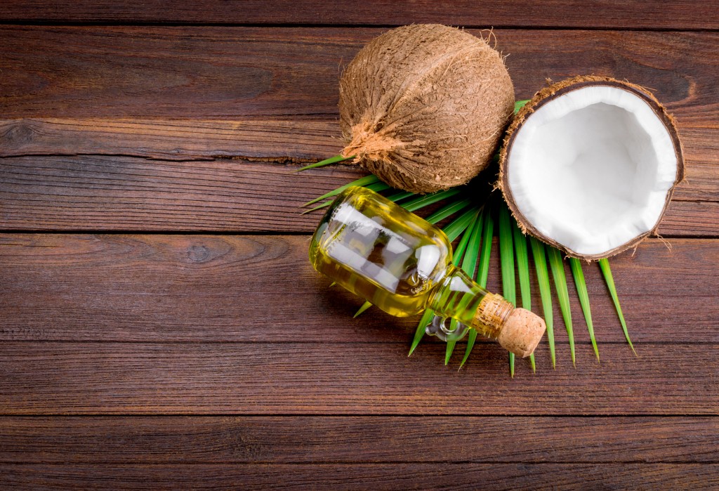 Coconut and coconut oil on wooden table