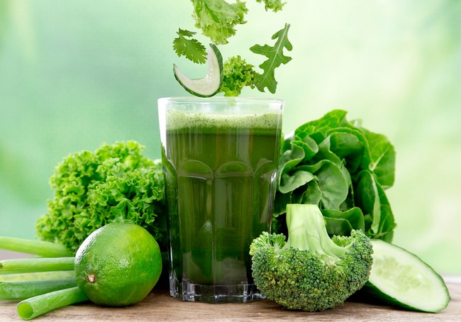 Healthy green vegetable juice on wooden table