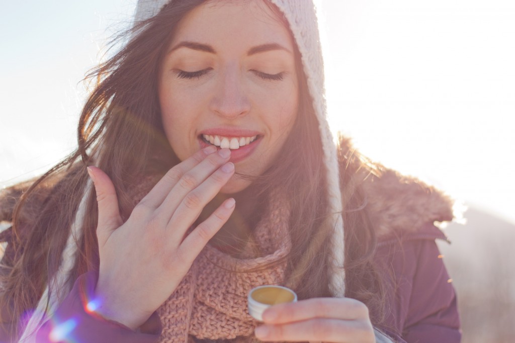 Women outdoor taking care of lips