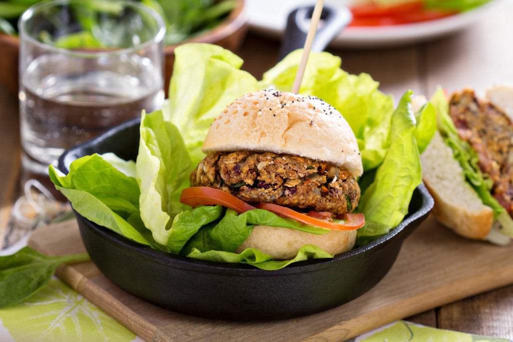 Vegan burgers with beans and vegetables served with spinach