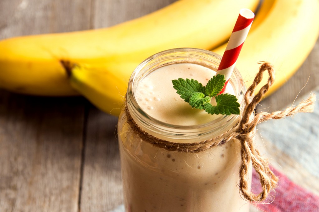 Banana smoothie on wooden background