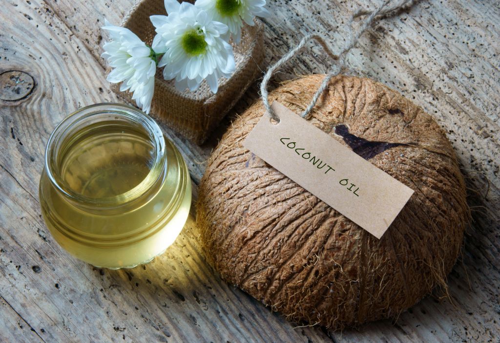 Coconut oil, essential oil from nature, a skin care that safe, rich vintamin, use in massage at spa, organic cosmetic on wooden background