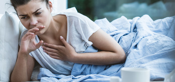 coughing-woman-on-couch