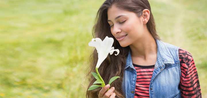 woman-smelling-flower