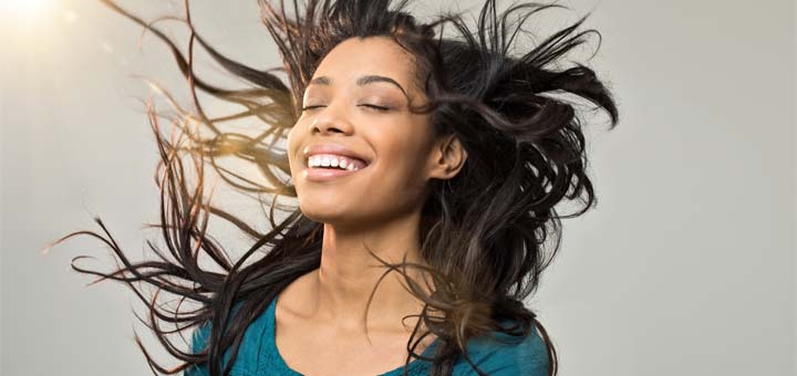 smiling-woman-blowing-hair