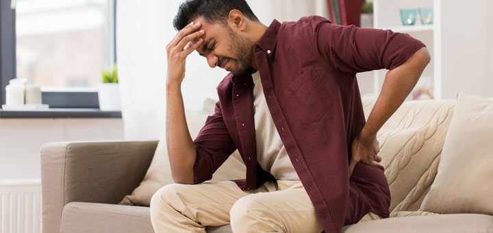 man-in-pain-on-couch