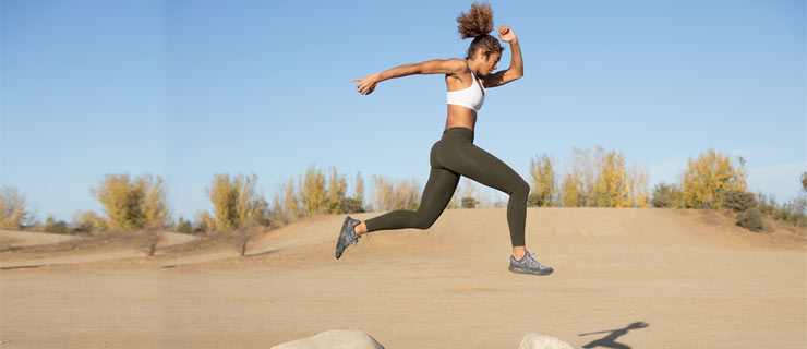 black-woman-jumping-rocks