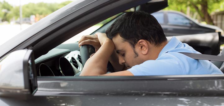 man-sleeping-in-car